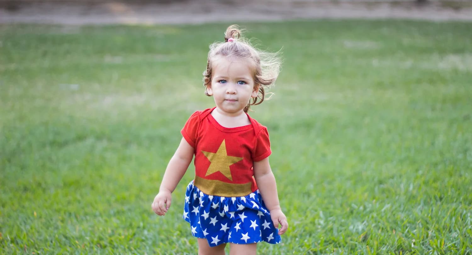 A child standing in the grass used as the hero image for the Advanced Certified ScrumMaster page.